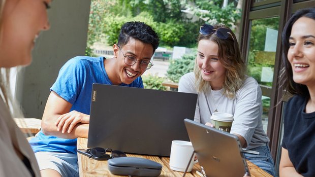 Happy students doing assignments